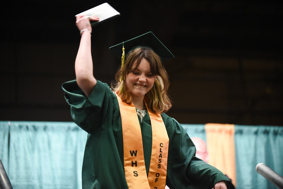 Kaiah Moore rocks out with her diploma during Saturday's Whitefish High School Graduation. (Daniel McKay/Whitefish Pilot)