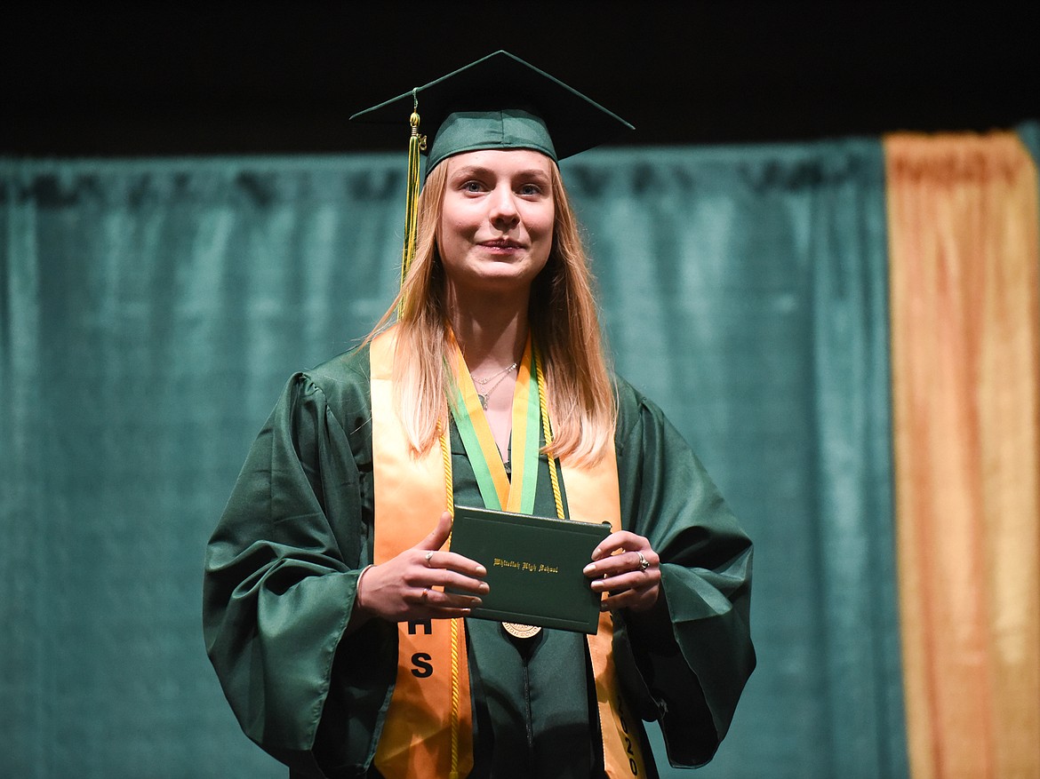 Elise Sabin smiles with her diploma during Saturday's Whitefish High School Graduation. (Daniel McKay/Whitefish Pilot)