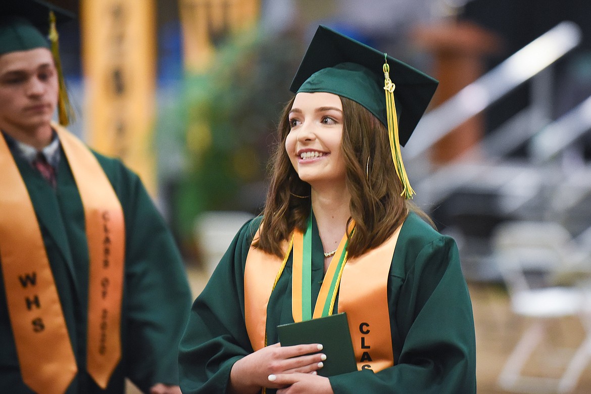 Alex Gunset smiles as she leaves Majestic Valley Arena with her diploma during Saturday's Whitefish High School Graduation. (Daniel McKay/Whitefish Pilot)