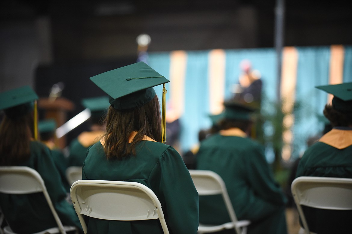 A student watches on as Principal Kerry Drown addresses her class during Saturday's Whitefish High School Graduation. (Daniel McKay/Whitefish Pilot)