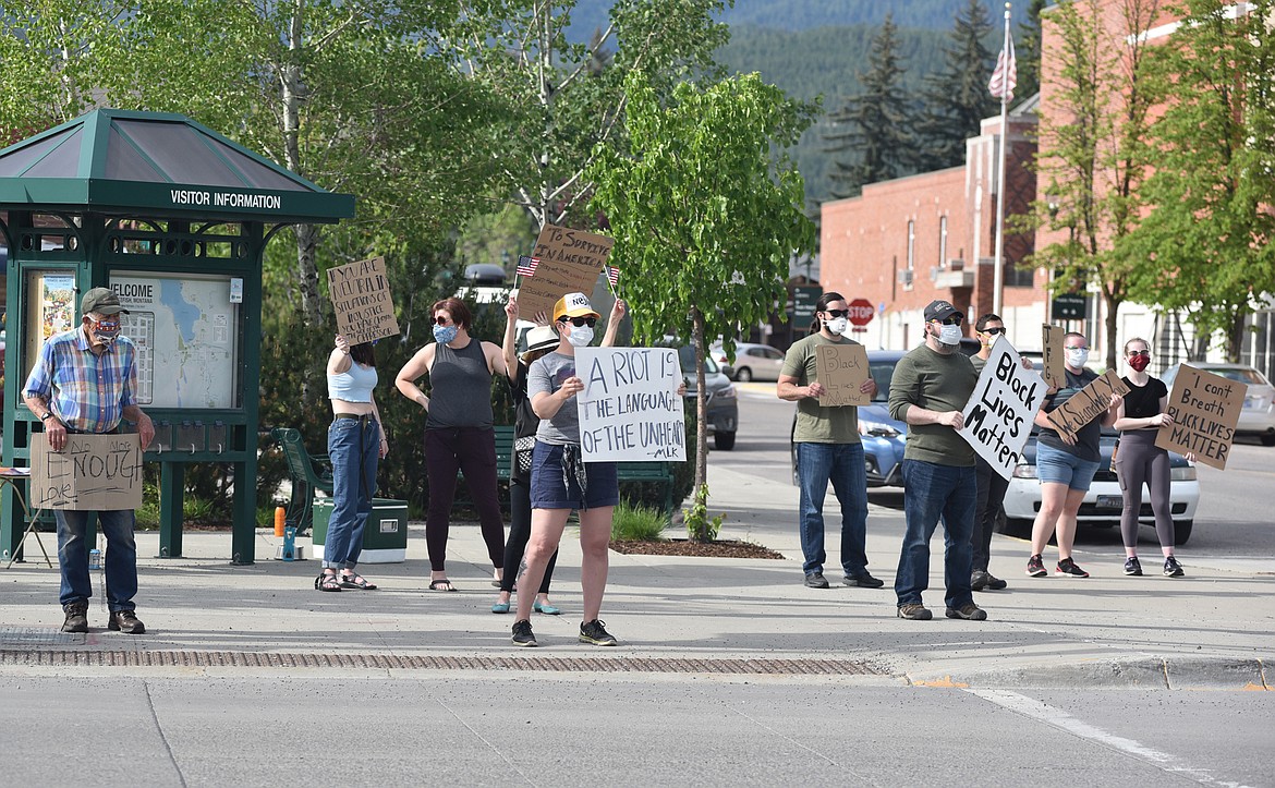 A group of demonstrators gather at the intersection of Second Street and Spokane Avenue in downtown Whitefish Wednesday evening. Demonstrators were protesting the recent death of George Floyd and showing support for the Black Lives Matter movement. A group also gathered in front of City Hall. (Heidi Desch/Whitefish Pilot)