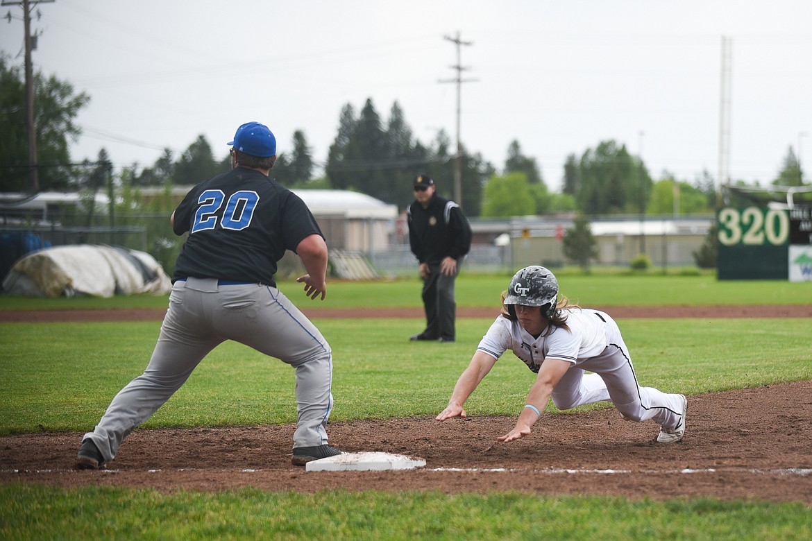 Cade Morgan narrowly avoids the pickoff attempt in the first of Sunday’s two games against Libby. (Daniel McKay/Whitefish Pilot)