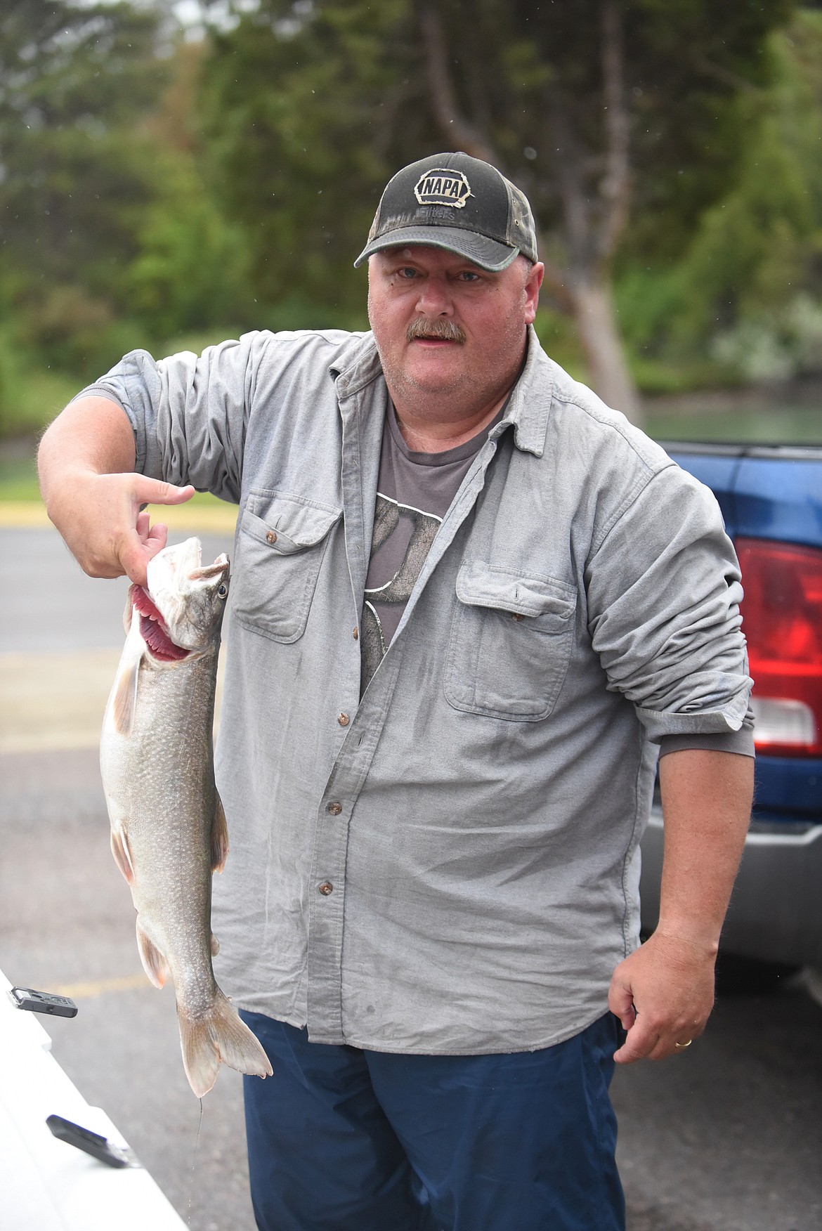 KALISPELL ANGLER Ron Seliger shows off one of the lake trout he caught Saturday in Flathead Lake during the Mack Days fishing tournament. (Scott Shindledecker/Daily Inter Lake)