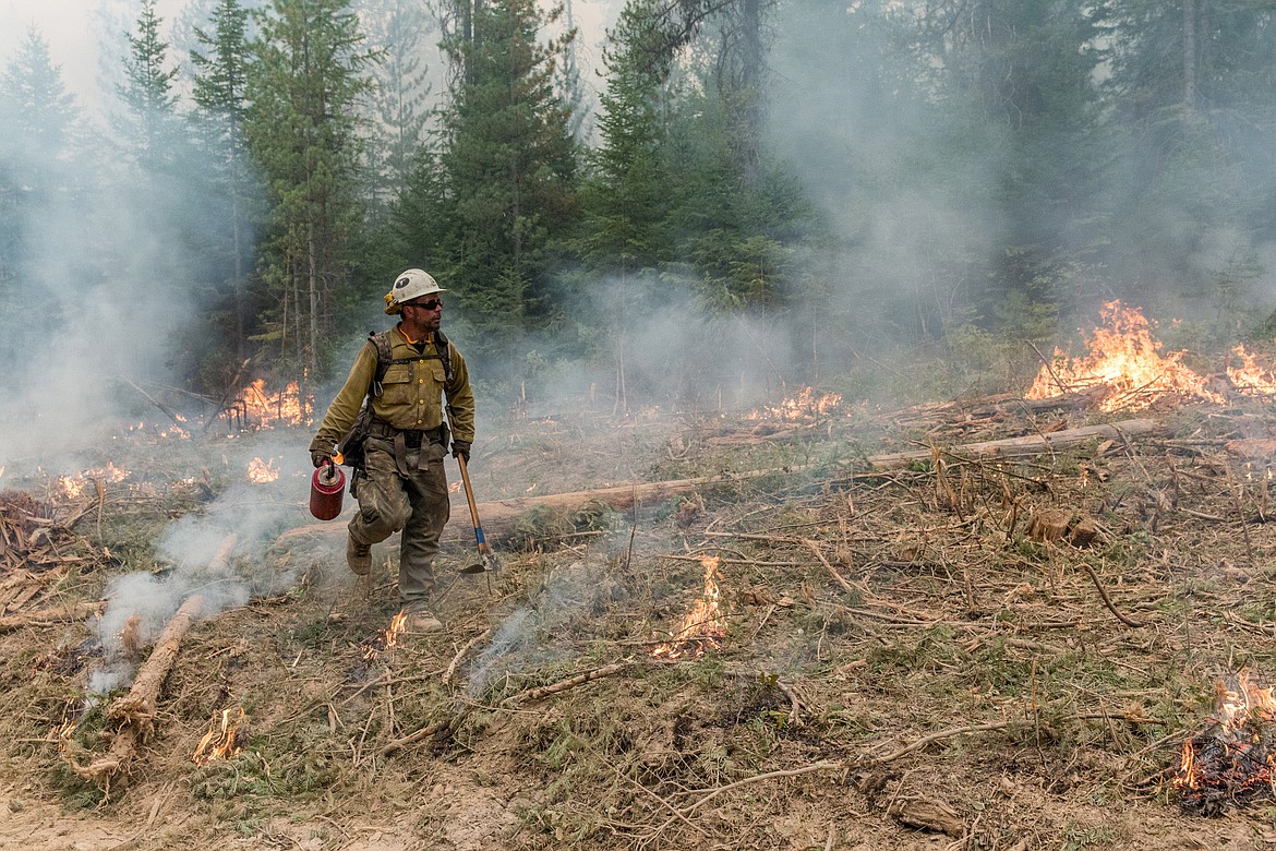 A Mesa Hotshots crew member works a controlled burn on the West Fork fire Friday, Sept. 8, 2017. (John Blodgett/The Western News)