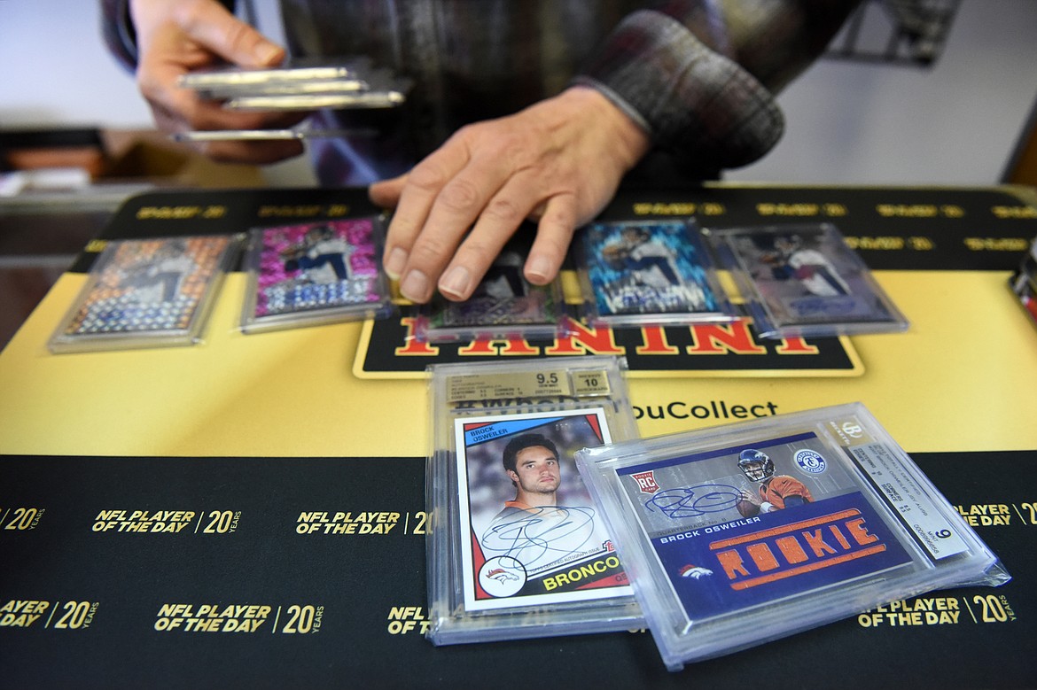 Tony Sibert sorts through a collection of signed Brock Osweiler cards at Sports Cards Plus.