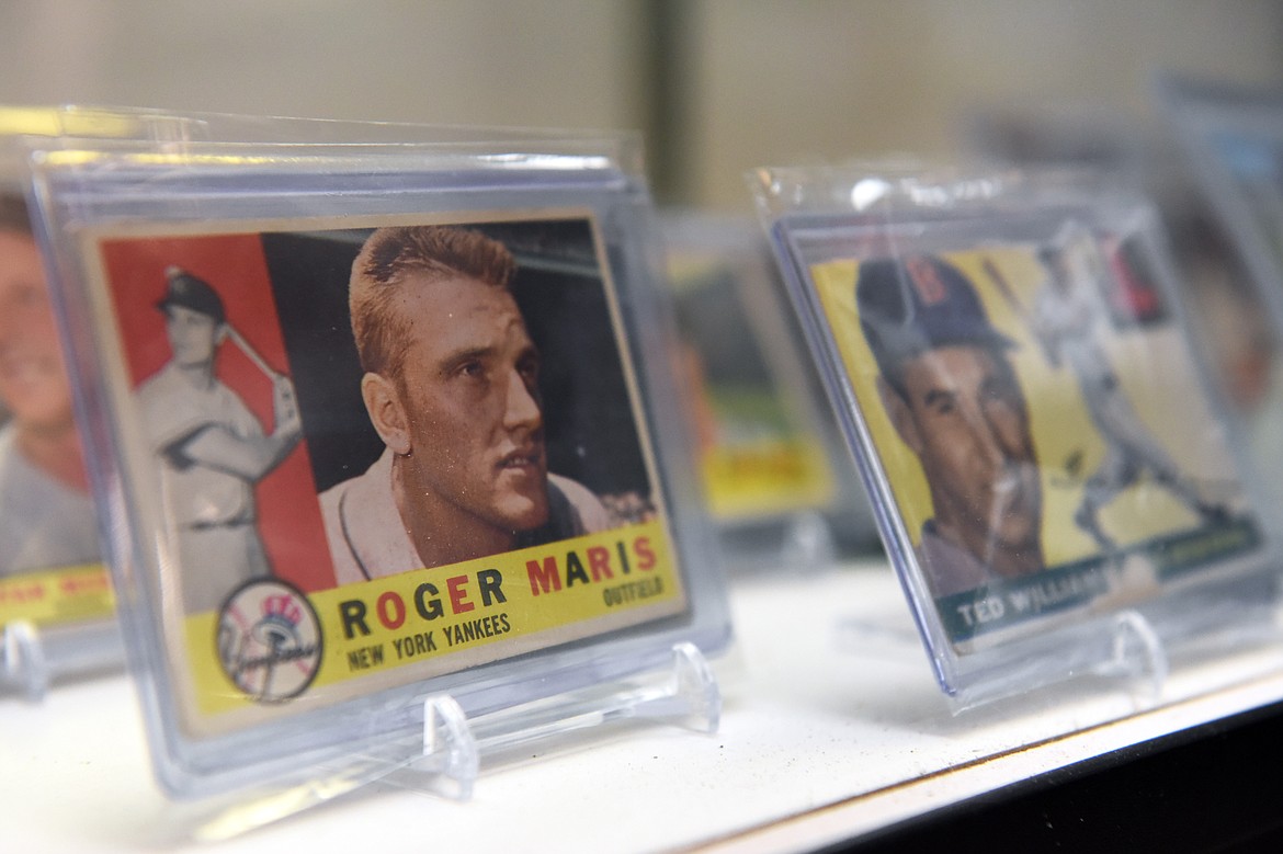 A 1960 Topps Roger Maris card and a 1955 Topps Ted Williams card for sale at Sports Cards Plus in Evergreen on Wednesday, June 10. (Casey Kreider/Daily Inter Lake)