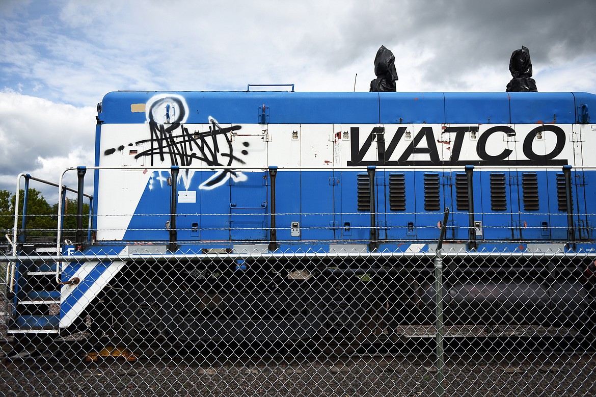 A train engine donated to the city of Kalispell by Mission Mountain Railroad sits inside a fence along a span of track above Woodland Park that will be developed into the Kalispell Trail on Tuesday, June 9. (Casey Kreider/Daily Inter Lake)