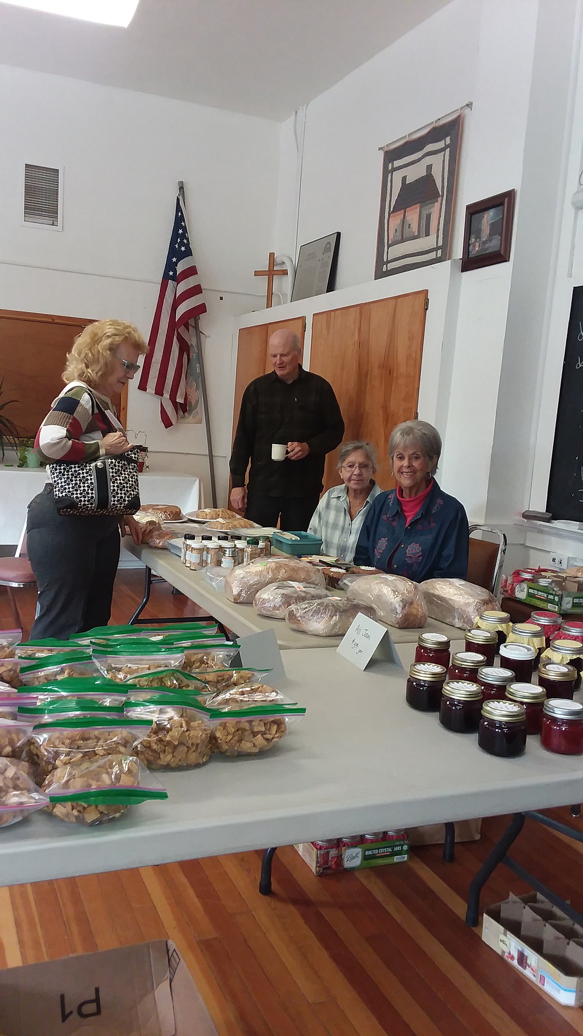 Gigi DuBois, blue shirt, and Diana Jones, vice president of the DeBorgia School Foundation sit in anticipation of bake sales last Wednesday. It was scheduled from 2 to 6 in the afternoon but stock was running low after the first hour. (Monte Turner/Mineral Independent)