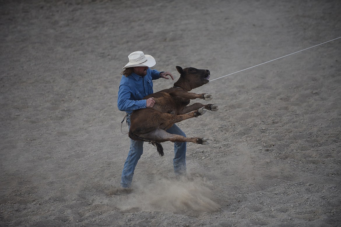 Chance Hays prepares to immoblize a calf during the tiedown roping event at the Hot Springs Rodeo June 13. (Scott Shindledecker/Valley Press)