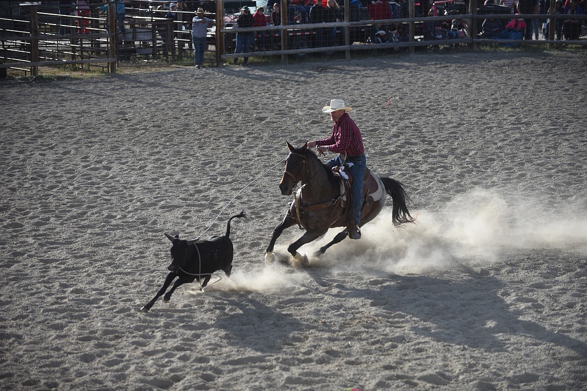 Josh Harris lassoes a calf during the men’s breakaway event June 13 at the Hot Springs Rodeo. (Scott Shindledecker/Clark Fork Valley Press)