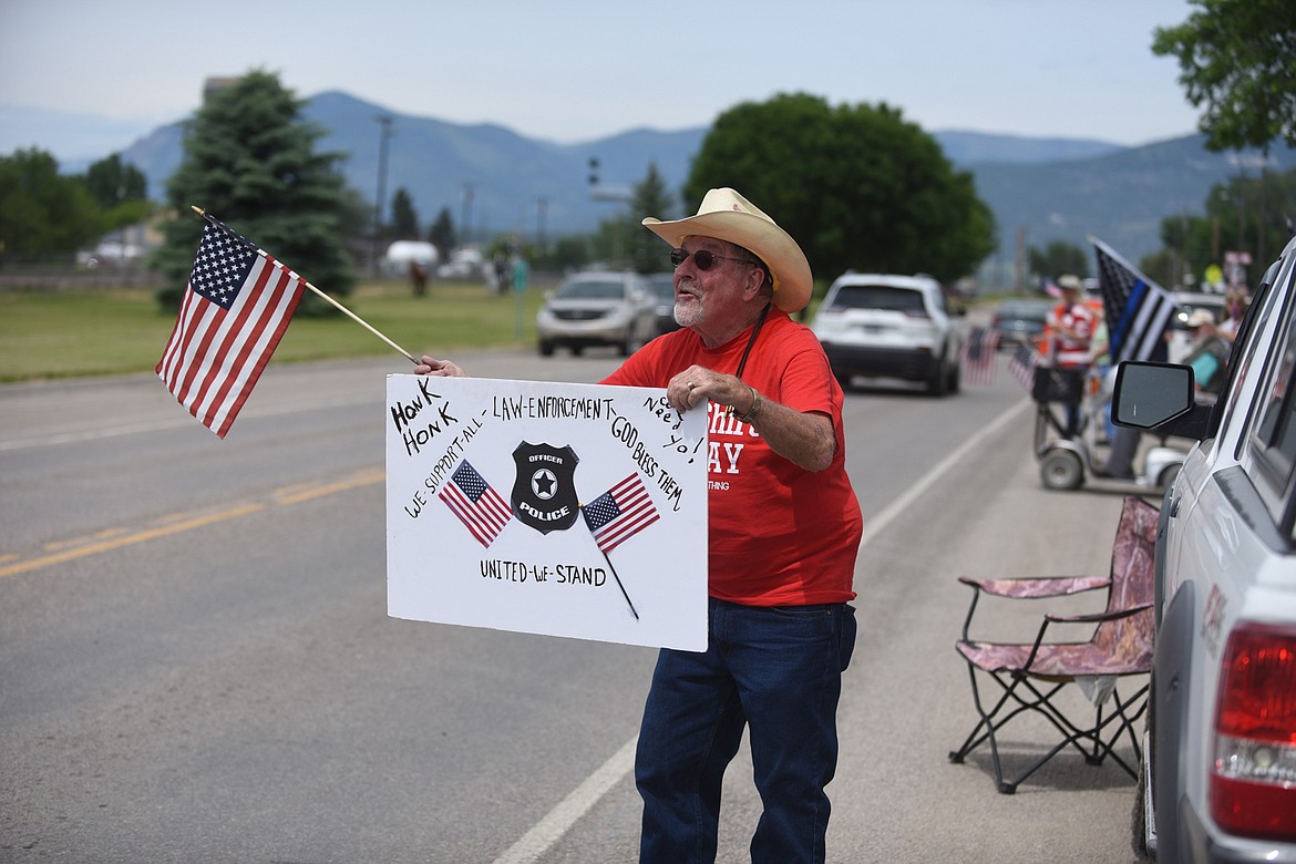 Plains resident Denny Powley shows his support for law enforcement officers Friday afternoon during a rally in Plains. (Scott Shindledecker/Valley Press)