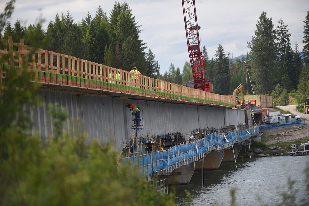 Contractors work on the Clark Fork River bridge at Trout Creek on Montana 200 last Friday. According to the Montana Department of Transportation, the bridge should be open to traffic by the middle of July and work should be finished sometime in September 2020. (Scott Shindledecker/Valley Press)