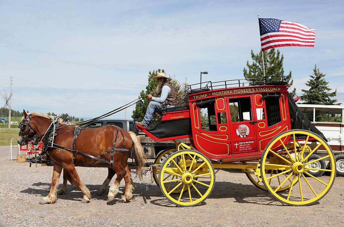 $ID/NormalParagraphStyle:Joshua Ragan drives a stagecoach built by his cousin, Gene Bushnell, in Bigfork last Friday. Bushnell used the coach to raise awareness for the pioneer values and President Donald Trump’s reelection.