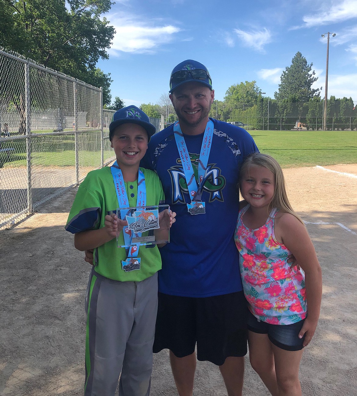 David Enquist, center, poses with his son Degan, left, and daughter Caroline.