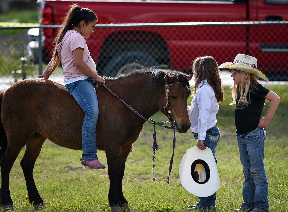 Young rodeo fans get together outside of the arena.