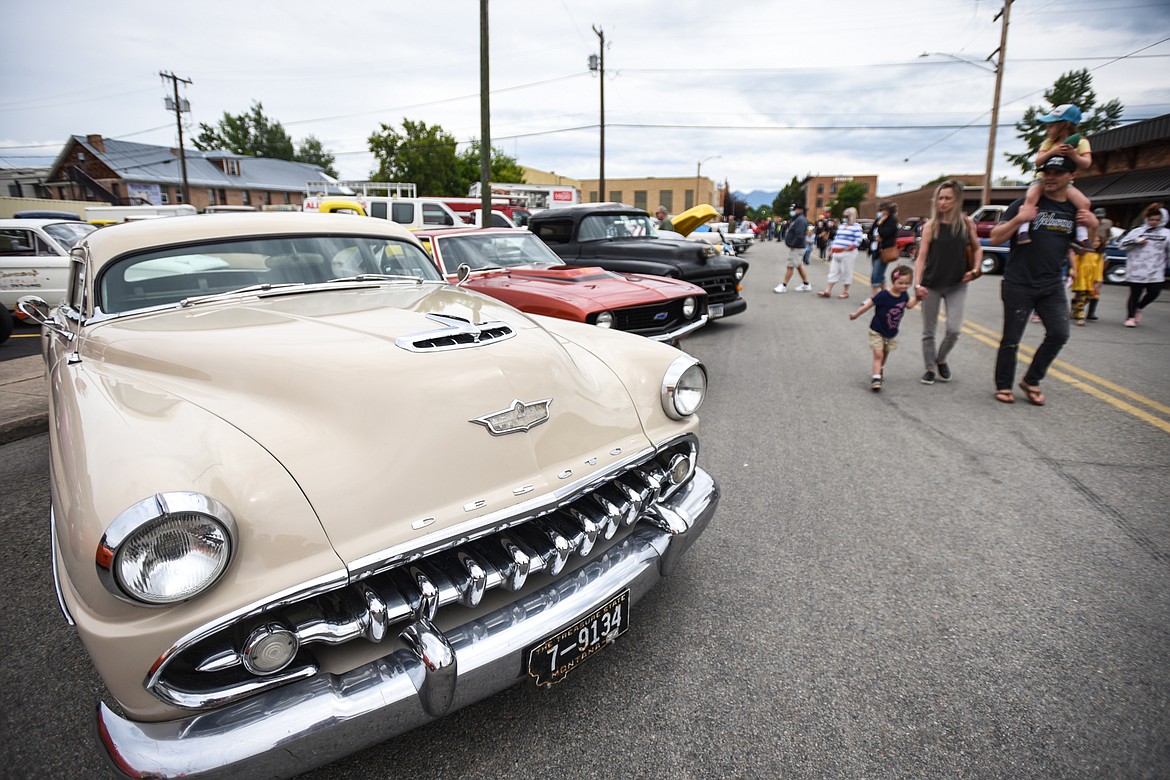 Attendees check out rows of classic cars at The Big Shindig car show hosted by The Glacier Street Rod Association and The Desoto Grill in Kalispell on Saturday, June 20. (Casey Kreider/Daily Inter Lake)