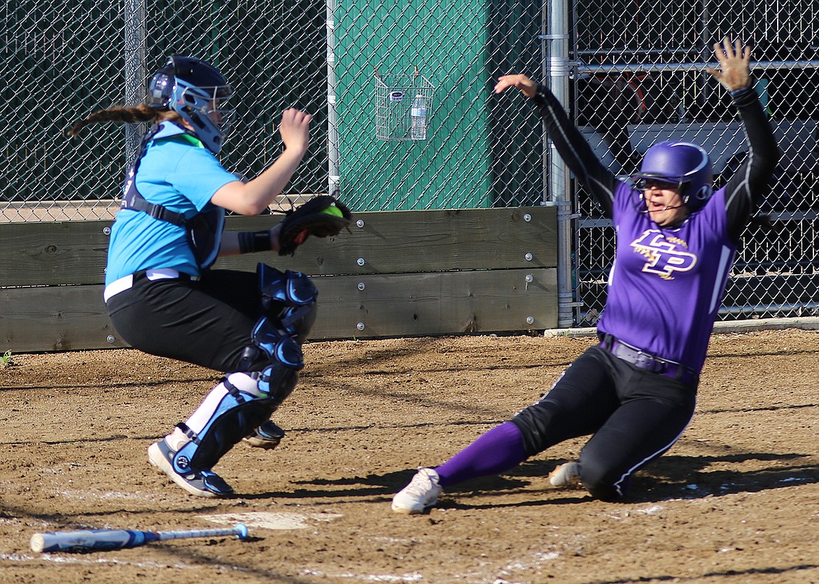 16U Polson's Mossy Kauley is safe as she slides into home at the Fall Fusion Classic softball tournament June 19-21. (Bob Gunderson photo)