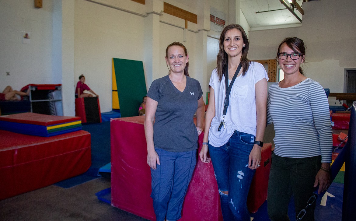 Casey McCarthy/Columbia Basin Herald 
 AIM Gymnastics Center owner Kortni Nelson and Alicia Taylor, Baylie Cole have been trying to make the most of limited space, while meeting social distancing measures, as gymnastics continue on this summer in Moses Lake.