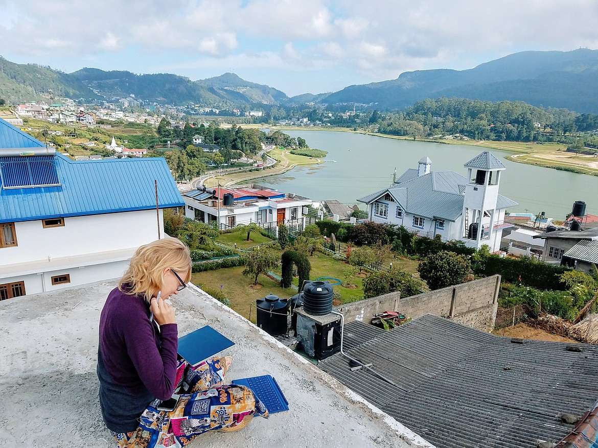 Sarah Weaver works on a comic from a rooftop in Sri Lanka.