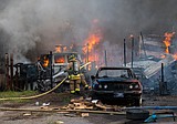 Fire destroys trailer home, vehicles
