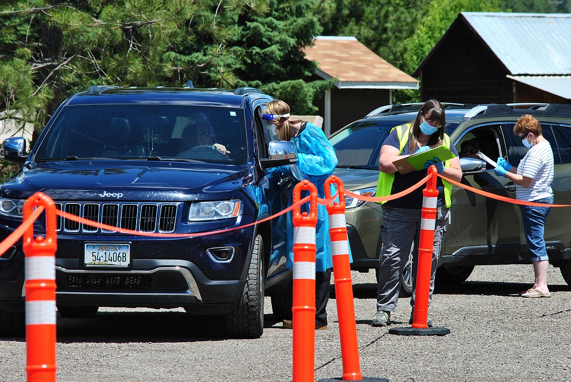 Shae Schoening, Lori Dove and Mary Simpson assist with the drive-through coronavirus testing during the community snapshot event in St. Regis Monday June 22. (Amy Quinlivan/Mineral Independent)