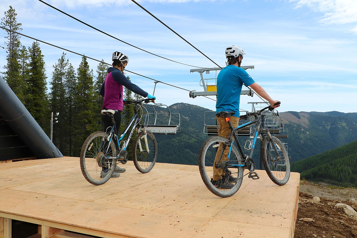 Riders stand with their mountain bikes on the platform at the top of the new Peak 1 Quad chairlift at Lookout Pass Ski and Recreation Area. (Photo courtesy Matt Sawyer, Lookout Pass)