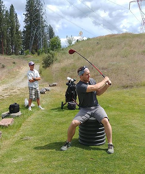 Noxon’s Nick Posselt tees off from a toilet seat contraption during Saturday’s annual Plains Hack and Blast event at the Wild Horse Plains Golf Club. (Chuck Bandel/Valley Press)