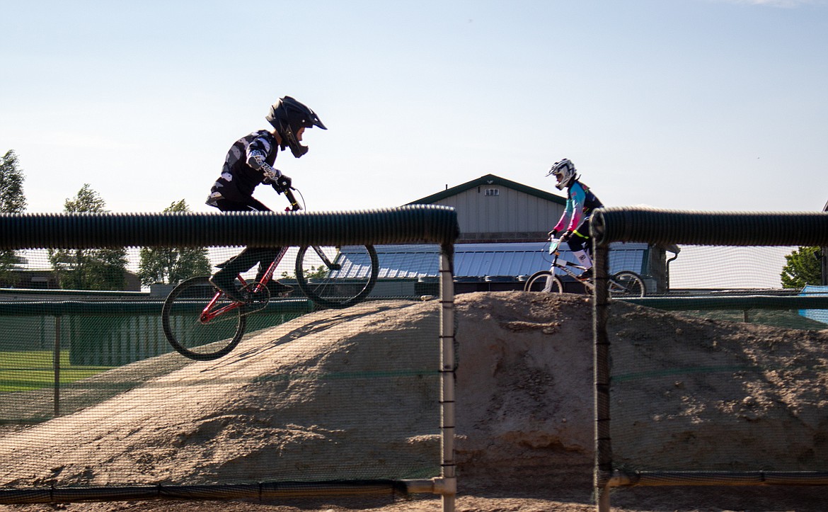 BMX riders Alex Bader, left, and Rikkin Salazar, right, make their way around Larson Recreation Center Track in Moses Lake on July 2.