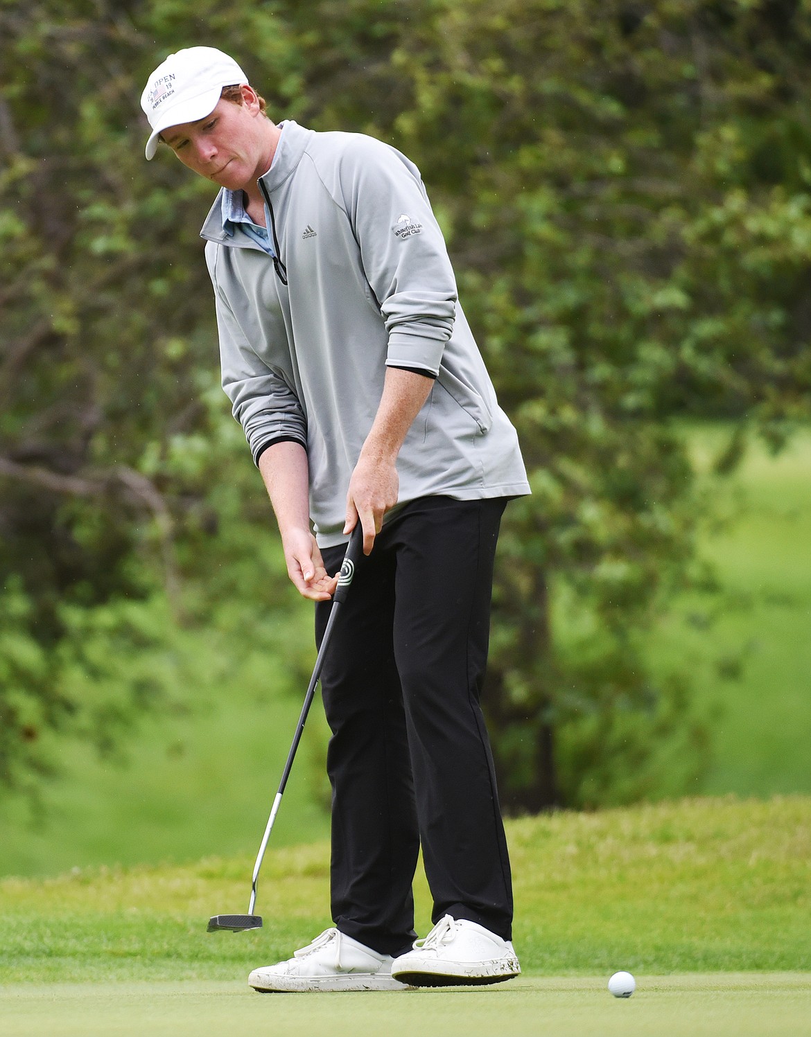 Cameron Kahle watches his putt on the 18th green of the North Course during the Earl Hunt 4th of July Tournament at Whitefish Lake Golf Club on Thursday, July 2. (Casey Kreider/Daily Inter Lake)