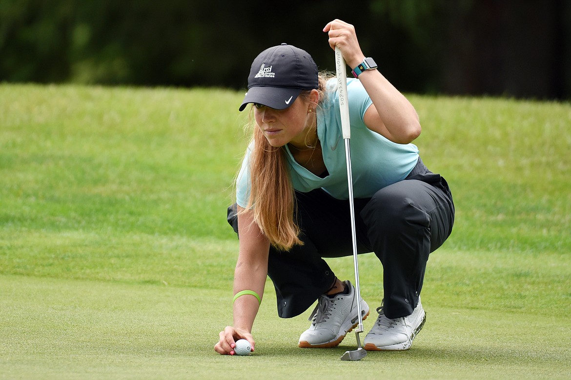 Teigan Avery lines up her putt on the 4th green of the South Course  during the Earl Hunt 4th of July Tournament at Whitefish Lake Golf Club on Thursday, July 2. (Casey Kreider/Daily Inter Lake)