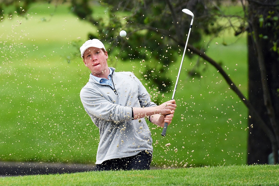 Cameron Kahle chips out of a sand trap on the 18th hole of the North Course during the Earl Hunt 4th of July Tournament at Whitefish Lake Golf Club on Thursday, July 2. (Casey Kreider/Daily Inter Lake)