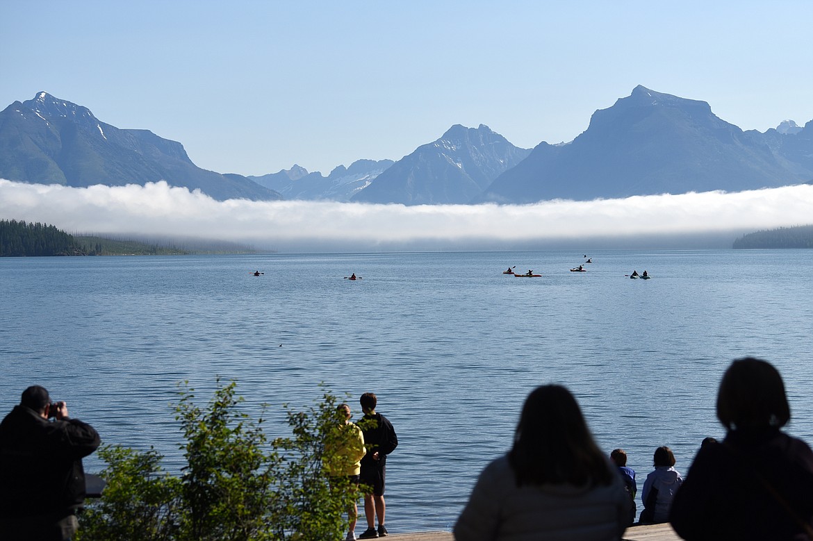 Visitors look out over Lake McDonald in Glacier National Park's Apgar Village on Friday, July 3. Due to traffic congestion and limited parking availability, access to the park's Going-to-the-Sun Road was temporarily restricted at Lake McDonald Lodge at 8:07 a.m. and at the foot of Lake McDonald at 8:51 a.m. Friday, according to the park's Twitter account. (Casey Kreider/Daily Inter Lake)
