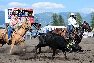 Brandon Brooks, left, of Whitefish, and Bart Slaney, of Whitefish, compete in team roping at the Bigfork Rodeo on Saturday, July 4. (Casey Kreider/Daily Inter Lake)
