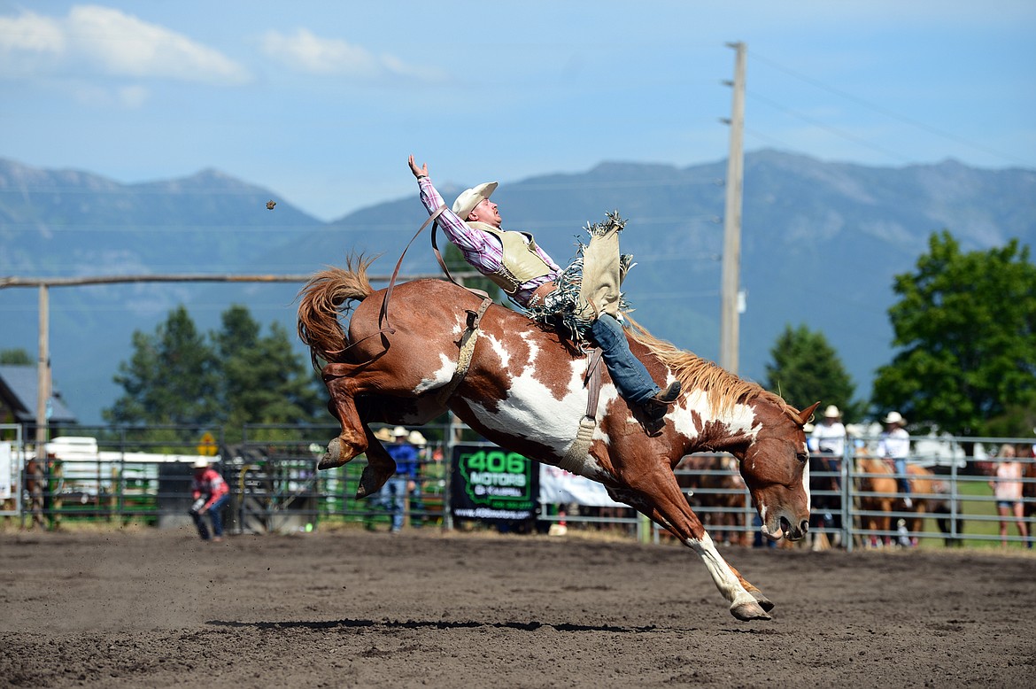 Trevor McAllister, of Ronan, holds on to his horse James Bond during bareback riding at the Bigfork Rodeo on Saturday, July 4. (Casey Kreider/Daily Inter Lake)