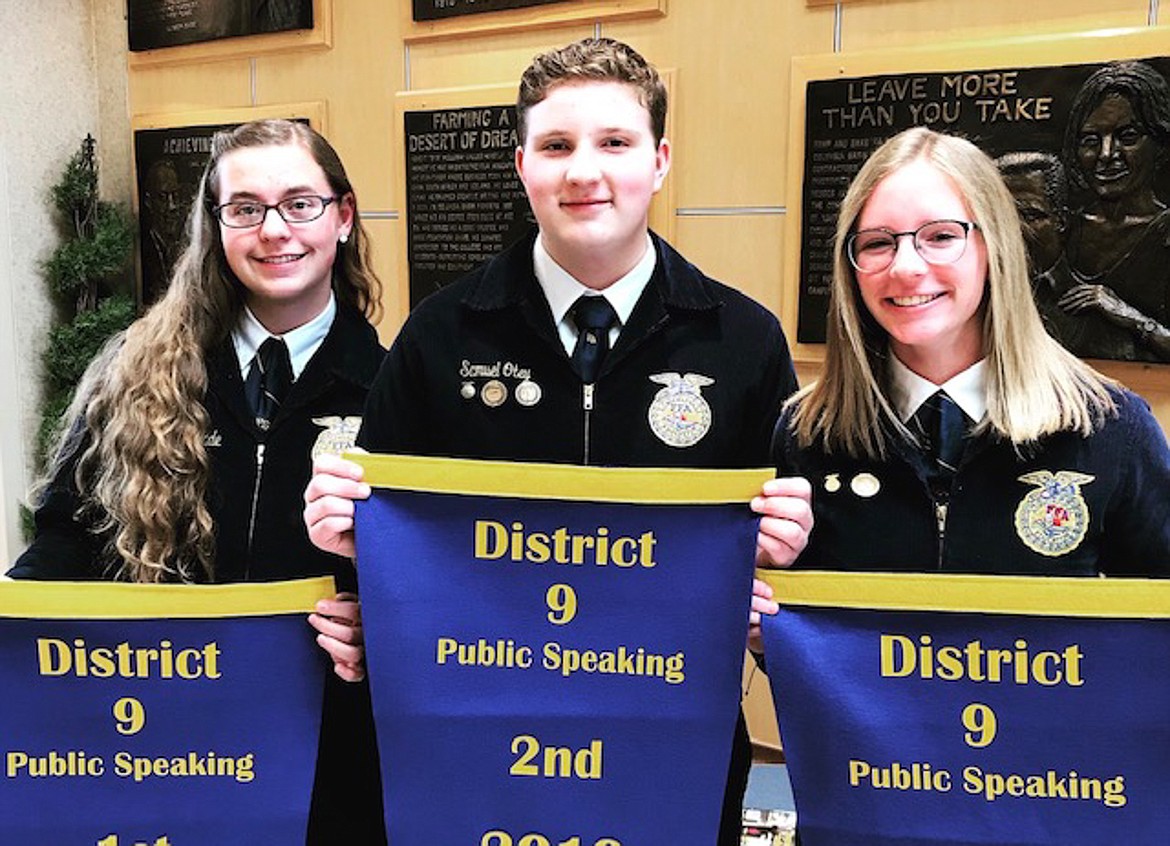 Left to right, Elisha Wade, Samuel Otey, and Maci Loutherback hold up their awards for the Public Speaking contest at the District IX competition in the spring.