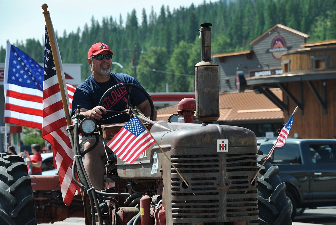 Matt Eisenbacher cruises on his International Harvester that once belonged to his late father, St. Regis resident Earl Eisenbacher. (Amy Quinlivan/Mineral Independent)