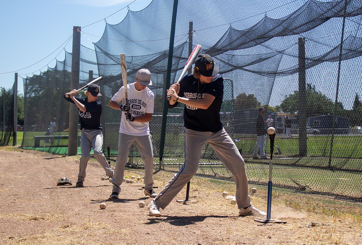 Columbia Basin Riverdogs players line up, spaced apart, for hitting practice on Wednesday as the team looks to ride their current momentum into the weekend.