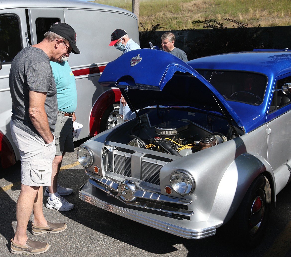 JASON ELLIOTT/Press 
 John Ader of Coeur d'Alene admires the 1951 Crosley Super Station Wagon of Hayden's Ron Chatters during the eighth annual Flames of the Spirit Car Cruise in Post Falls.