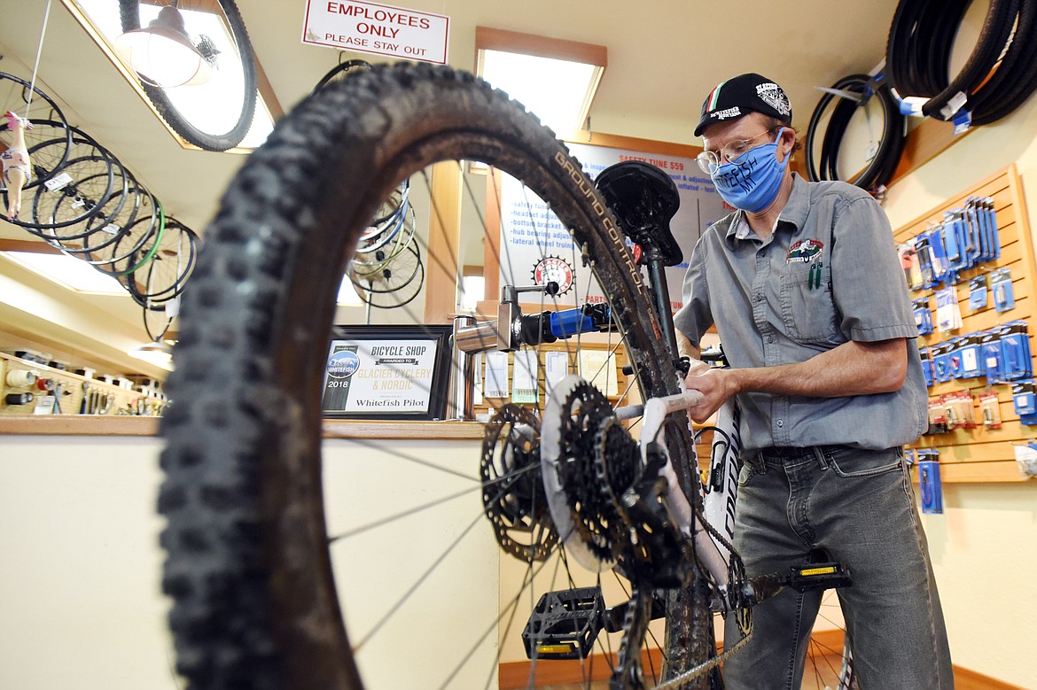 Mark Ambre checks in a customer's trade-in bicycle at Glacier Cyclery & Nordic in Whitefish on Friday, July 10. (Casey Kreider/Daily Inter Lake)