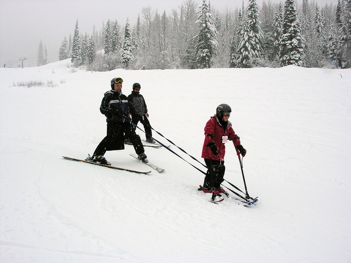 Jerry Mahugh helps a local man with cerebral palsy learn to ski. (Photo provided by DREAM Adaptive)