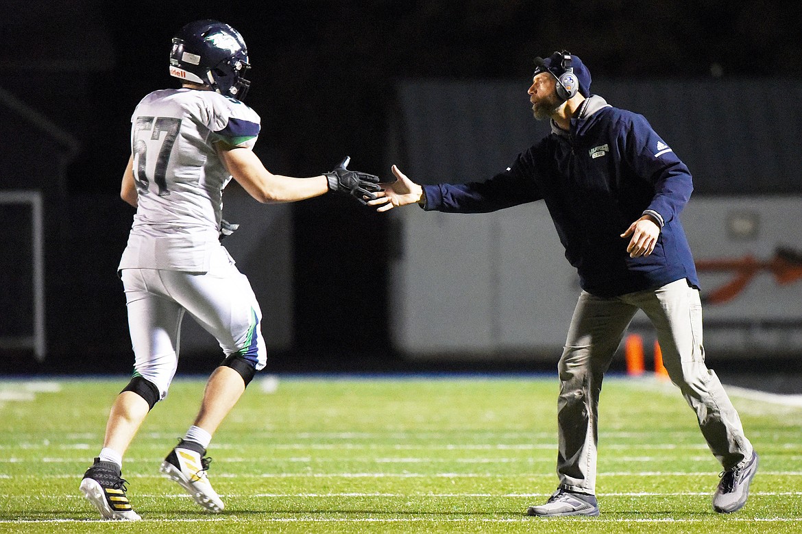 Glacier head coach Grady Bennett congratulates defensive lineman Henry Nuce (57) in the second half against Flathead during a crosstown matchup at Legends Stadium on Friday, Oct. 18, 2019. (Casey Kreider/Daily Inter Lake)