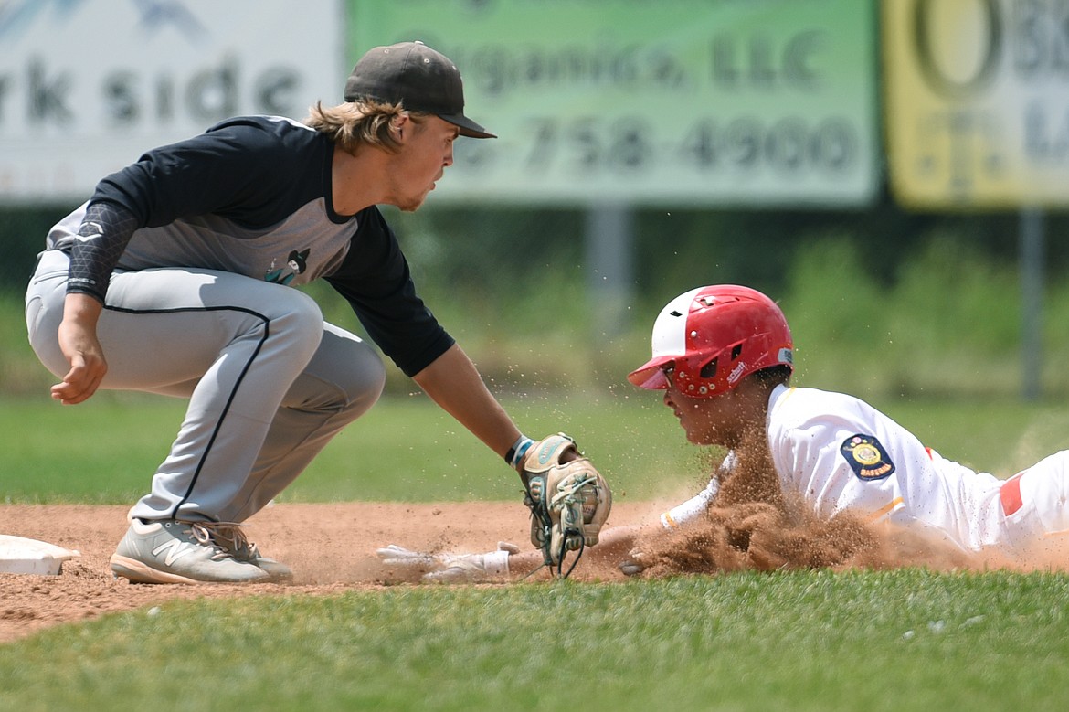 Kalispell Lakers AA’s Kostya Hoffman is tagged out at second base by Belgrade shortstop Lane Neill after getting caught in a rundown at Griffin Field on Thursday, July 16. (Casey Kreider/Daily Inter Lake)