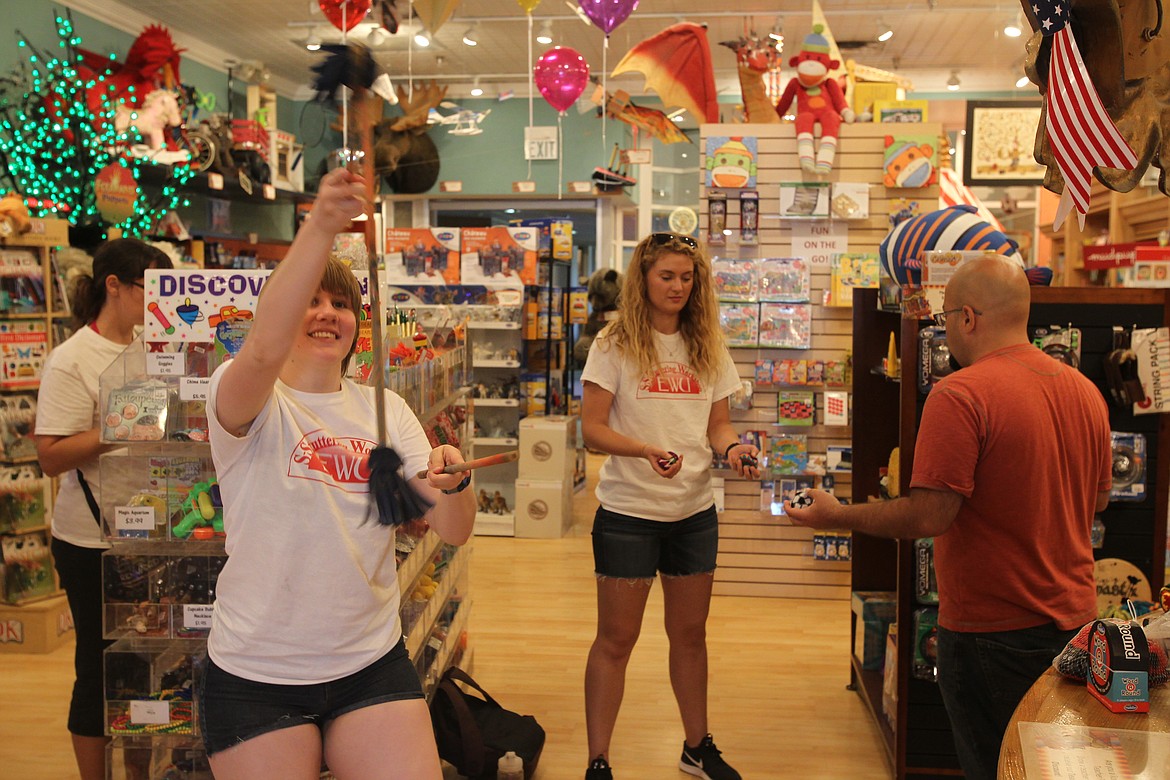 Charly Olson, left, and Sarah Naglich test kinetic toys at Figpickels Toy Emporium on a summer morning in 2017. Figpickels is now offering its customers virtual shopping experiences where shoppers can wander through the store with a representative and see how toys work in real time via video chat. (MITCHELL BONDS/Press File)