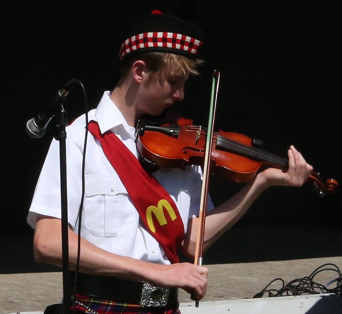 JASON ELLIOTT/Press 
 Rathdrum's Wayne Cardwell performs a fiddle solo during a performance by the Albeni Falls Pipe and Drum band during Rathdrum Days on Saturday.