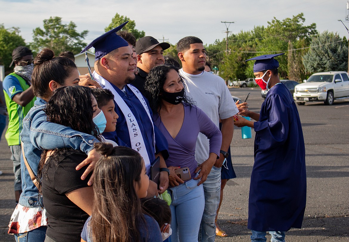 Casey McCarthy/The Sun Tribune
2020 Desert Oasis High School graduate Jesus Garcia poses for a photo with family and friends who came out to support him last Thursday, July 16, in Othello.