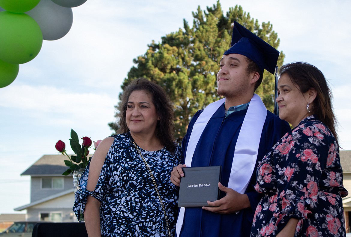 Casey McCarthy/The Sun Tribune
2020 Desert Oasis High School graduate Andre Dickerson poses for a photo with family on stage at the high school’s graduation ceremony on Thursday, July 16.