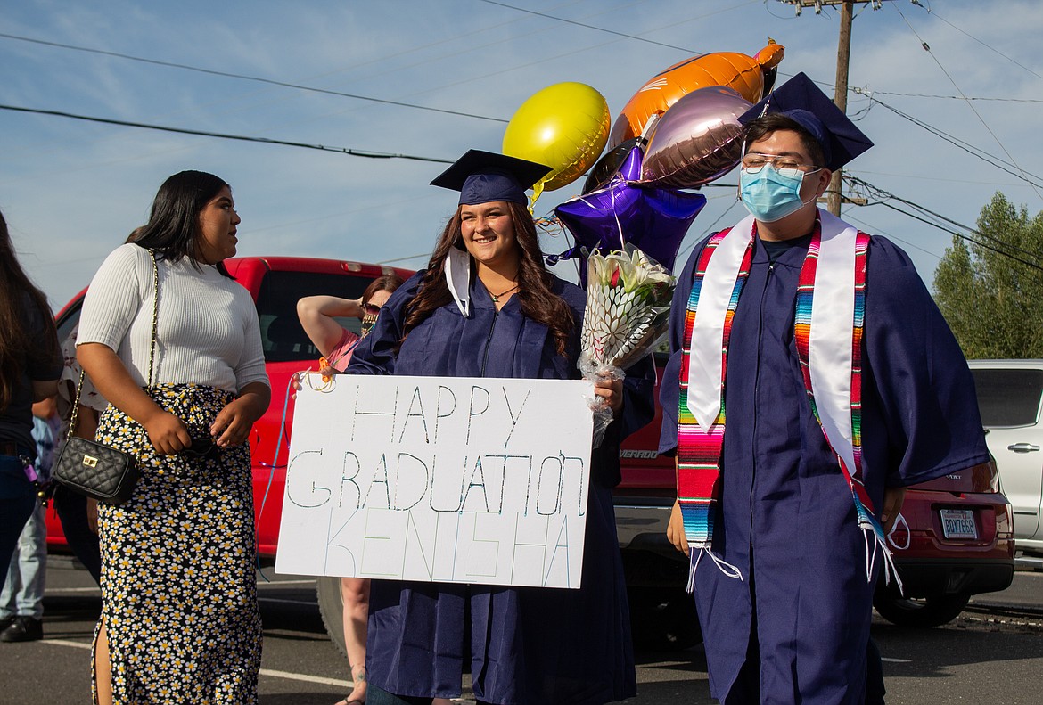 Casey McCarthy/The Sun Tribune 
 Desert Oasis High School graduates Kenisha Bailey and Julian Flores celebrate together before graduation ceremonies begin last Thursday evening in Othello.