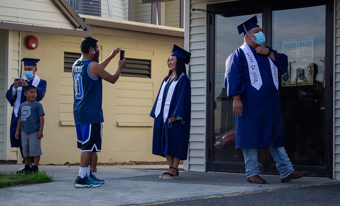 Casey McCarthy/The Sun Tribune 
 Desert Oasis High School graduates take photos and bide their time as they wait for their chance to walk across the stage at the 2020 graduation ceremony on Thursday, July 16.