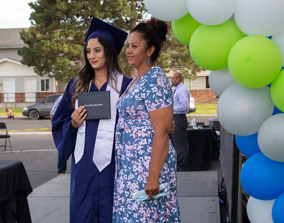 Casey McCarthy/The Sun Tribune
2020 Desert Oasis graduate Samantha Prieto poses for a family photo on stage at the high school’s graduation celebration last Thursday evening in Othello.