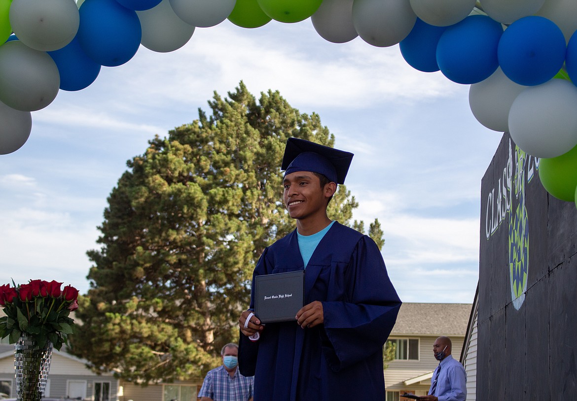 Casey McCarthy/The Sun Tribune
Desert Oasis graduate Adrian Velasquez poses for a photo after receiving his diploma cover at the high school’s 2020 graduation ceremony last Thursday evening.